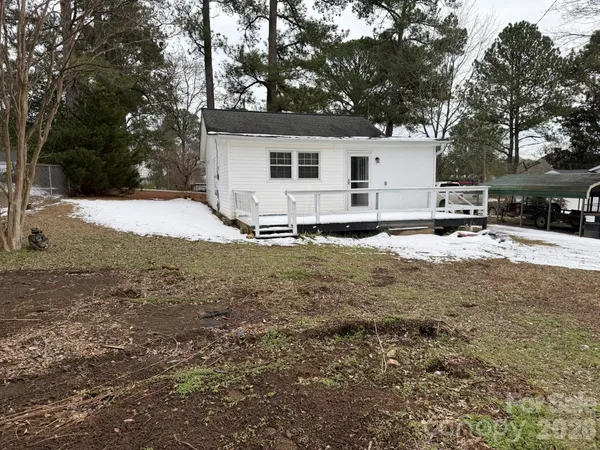 a backyard of a house with basket ball court and outdoor seating