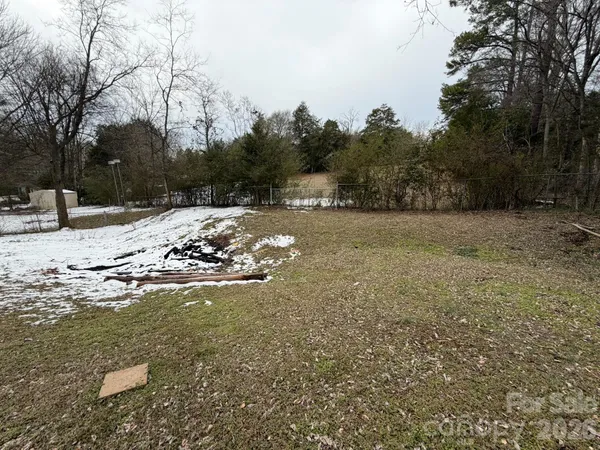 a view of a yard covered with snow in the outdoor space