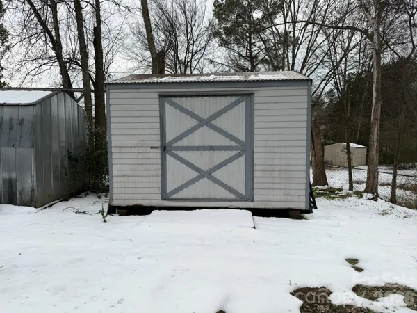 a view of a patio with table and chairs under an umbrella