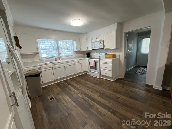 a kitchen with cabinets a sink and appliances
