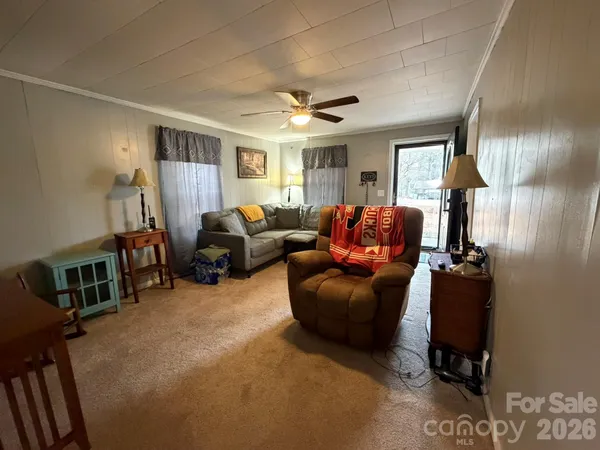 a living room with furniture a lamp and a flat screen tv