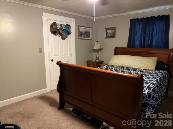 a bedroom with bed and wooden floor