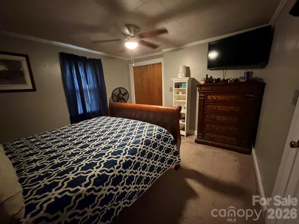 a bedroom with a bed and a television