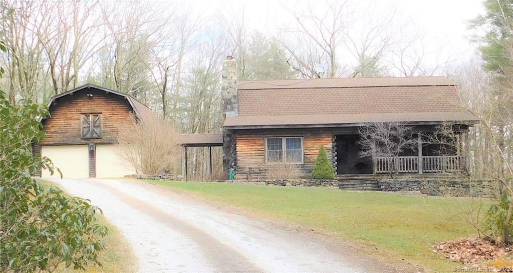 28 Pine Road Colebrook, CT 06021 - Photo 1 of 1 a front view of a house with a yard garage and outdoor seating