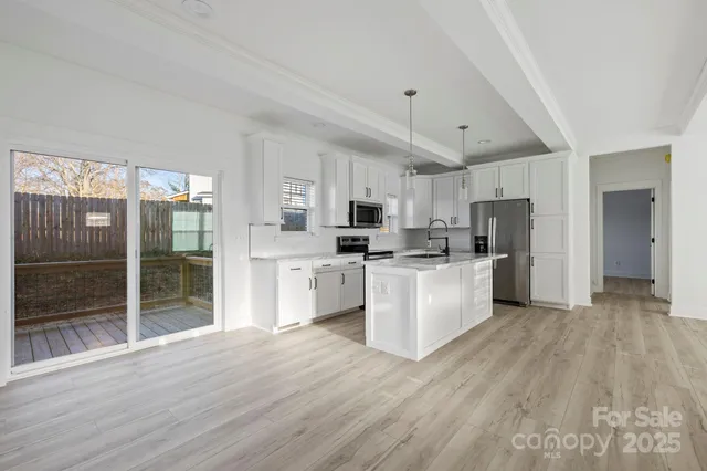 a kitchen with stainless steel appliances a refrigerator sink and cabinets