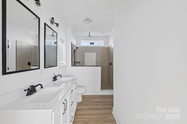 a bathroom with a double vanity sink and mirror