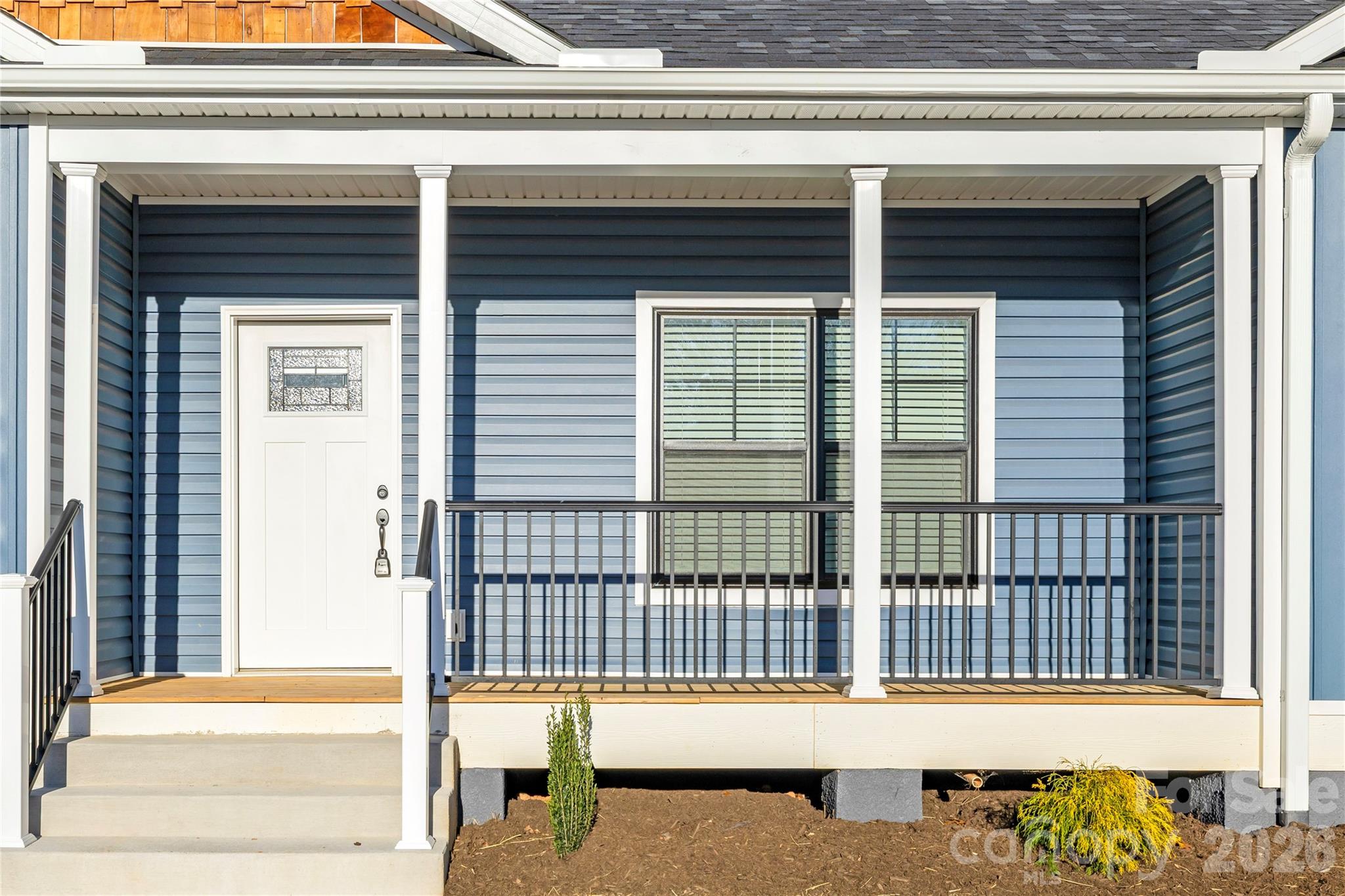 204 Southern Charm Road Arden, NC 28704 - Photo 2 of 24 a porch with a chair
