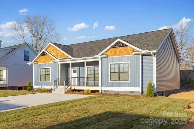 a view of a house with backyard and swimming pool