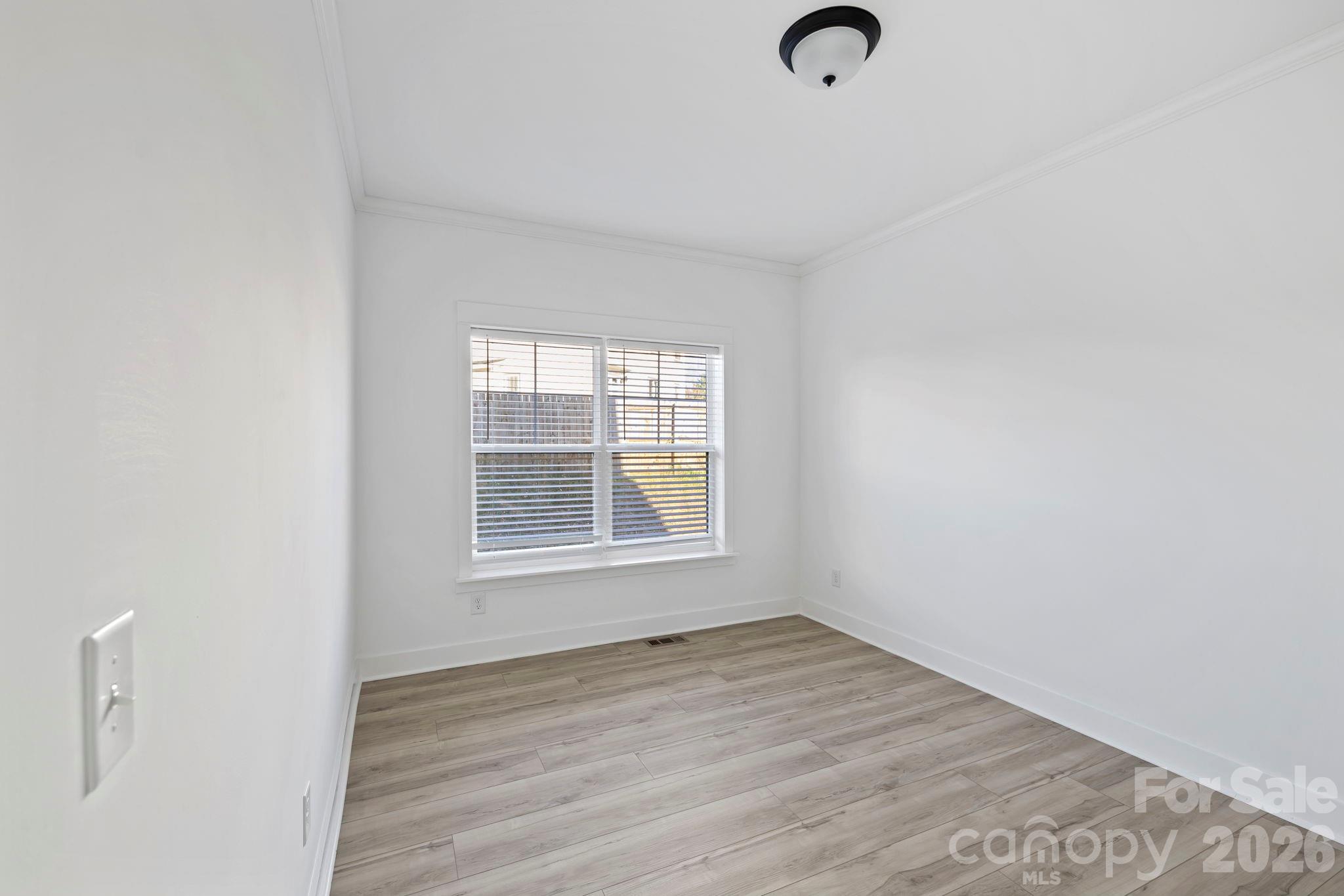 204 Southern Charm Road Arden, NC 28704 - Photo 22 of 24 an empty room with wooden floor and windows