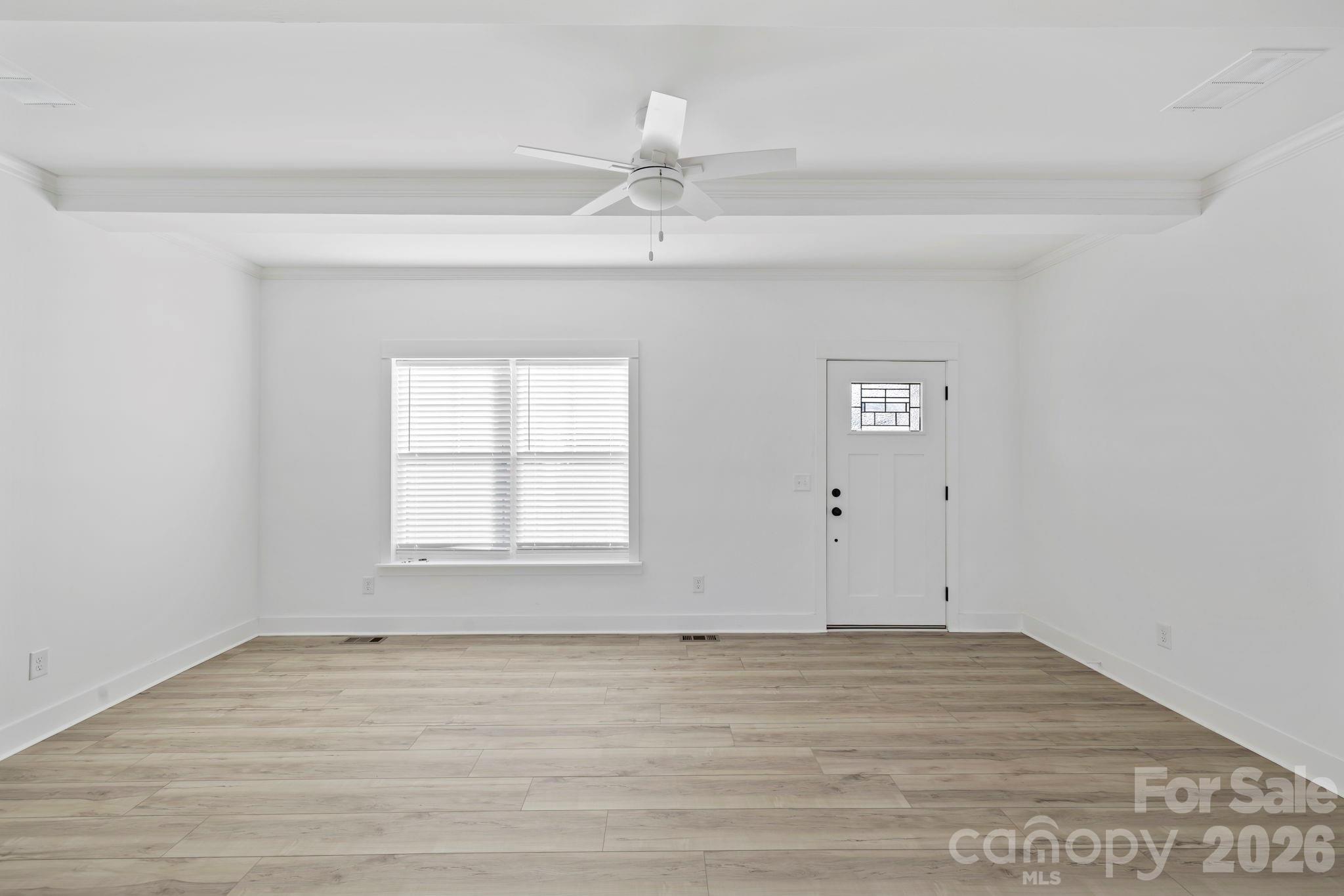 204 Southern Charm Road Arden, NC 28704 - Photo 6 of 24 an empty room with wooden floor fan and window