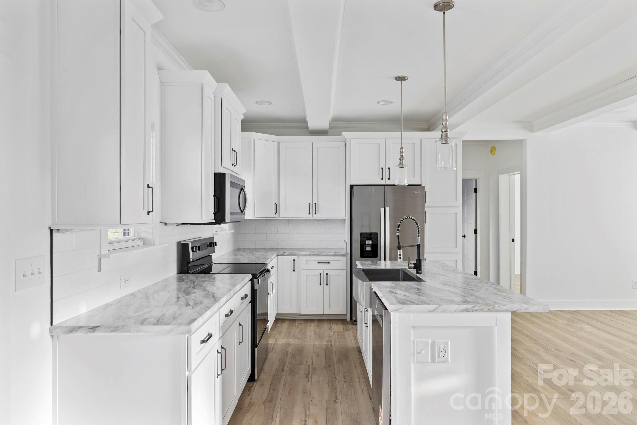 204 Southern Charm Road Arden, NC 28704 - Photo 9 of 24 a kitchen with stainless steel appliances granite countertop a sink stove and refrigerator