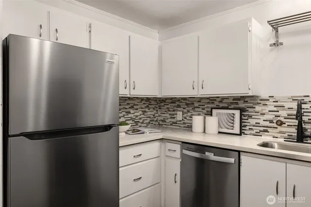 a kitchen with stainless steel appliances granite countertop a refrigerator and a sink