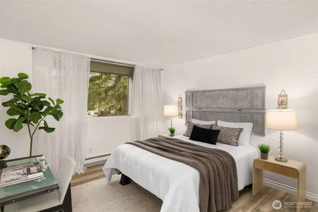 a bedroom with a bed potted plant and a window