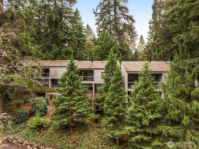 a view of a house with a yard and sitting area