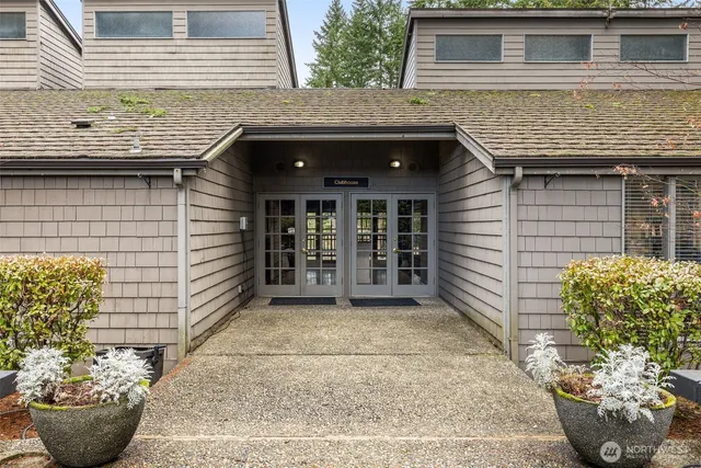 a view of a house with potted plants