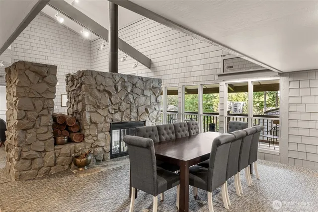 a view of a dining room with furniture and chandelier