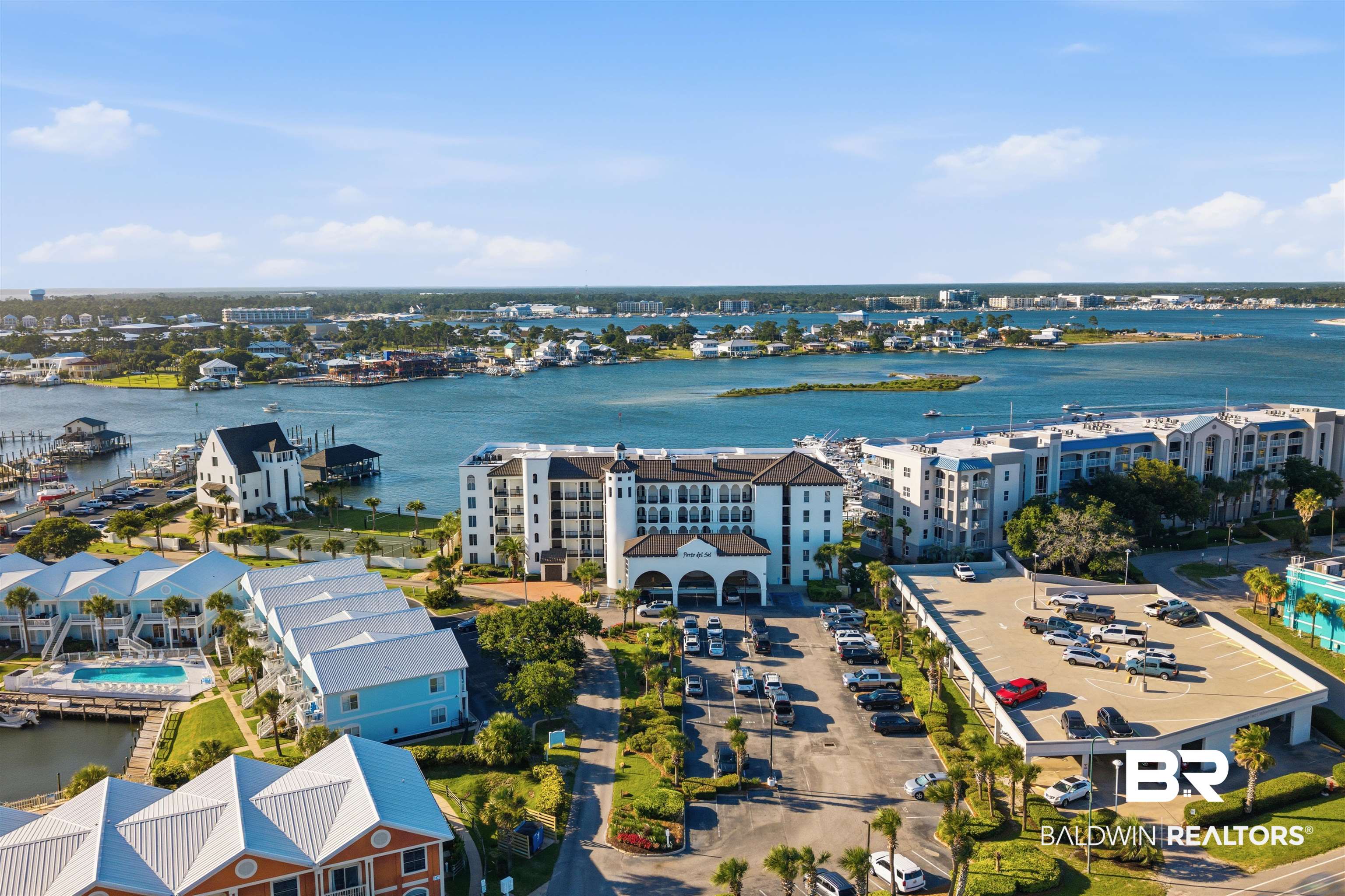 3564 Bayou Road, Unit 203 Orange Beach, AL 36561 - Photo 47 of 53 Waterfront property featuring multiple buildings, marina access with boat slips, an outdoor swimming pool, and dedicated parking structures