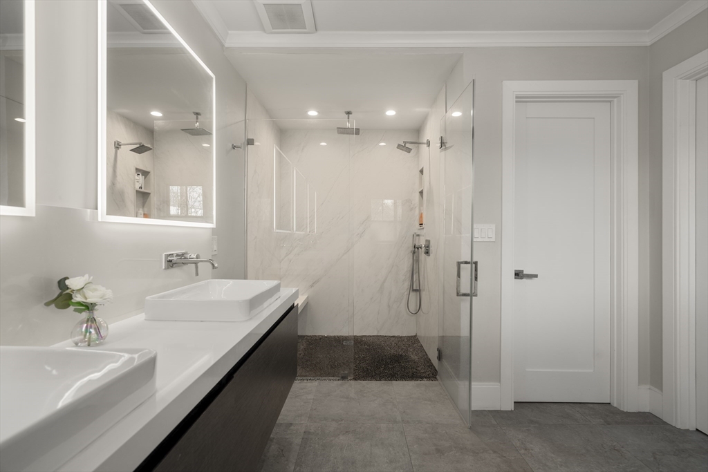 148 Kent Street, Unit 148 Brookline, MA 02446 - Photo 11 of 19 a bathroom with a sink a large mirror and shower