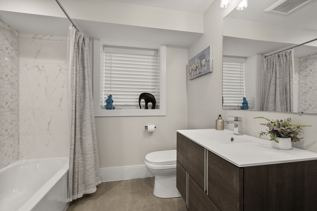 148 Kent Street, Unit 148 Brookline, MA 02446 - Photo 16 of 19 a bathroom with a sink a toilet and shower