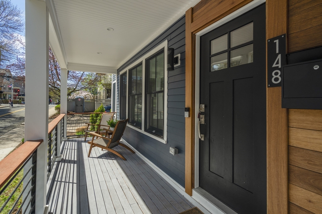 148 Kent Street, Unit 148 Brookline, MA 02446 - Photo 18 of 19 a balcony with wooden floor table and chairs