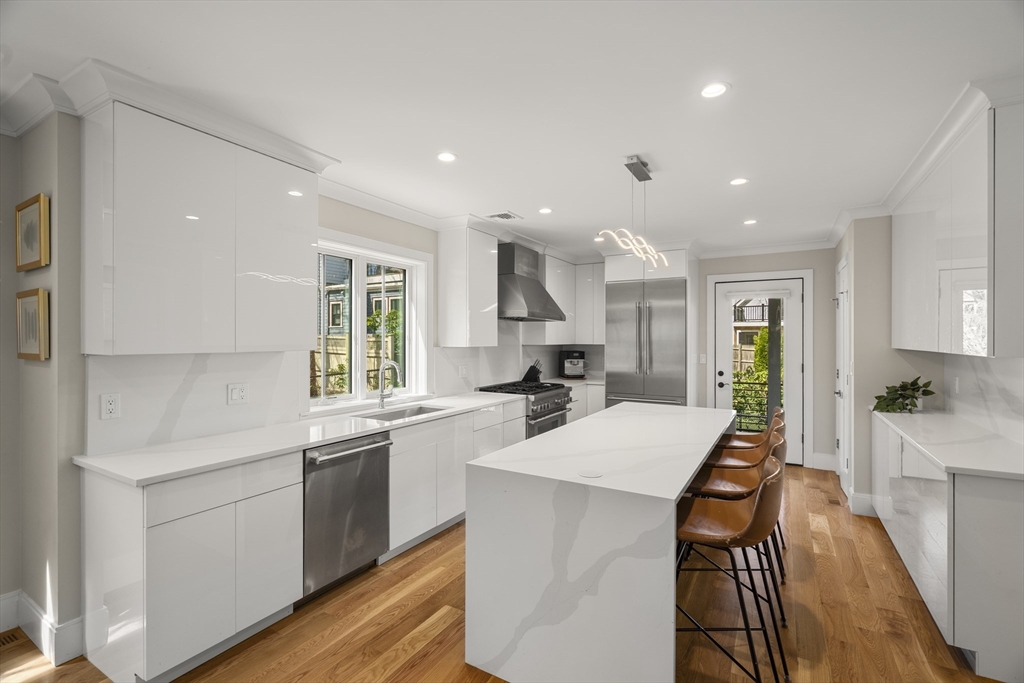 148 Kent Street, Unit 148 Brookline, MA 02446 - Photo 2 of 19 a large kitchen with a table and chairs in it