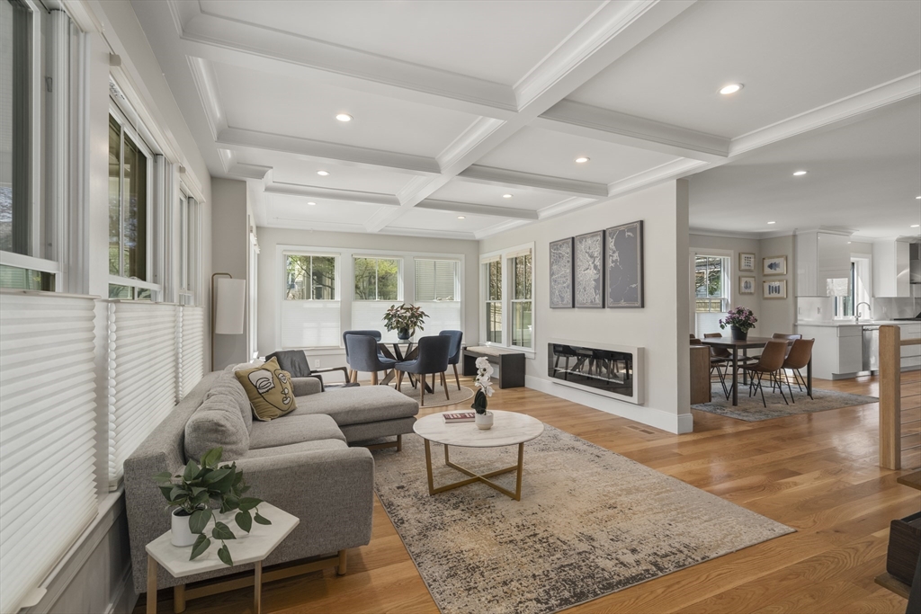 148 Kent Street, Unit 148 Brookline, MA 02446 - Photo 7 of 19 a living room with furniture a fireplace and a table