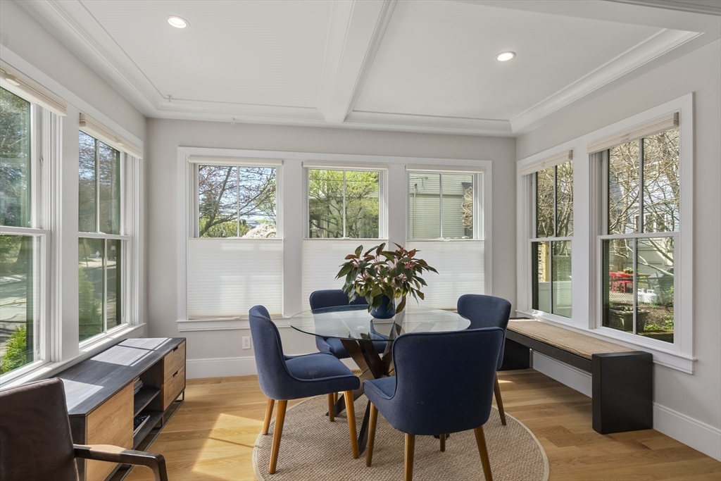 148 Kent Street, Unit 148 Brookline, MA 02446 - Photo 8 of 19 a dining room with furniture a chandelier and wooden floor