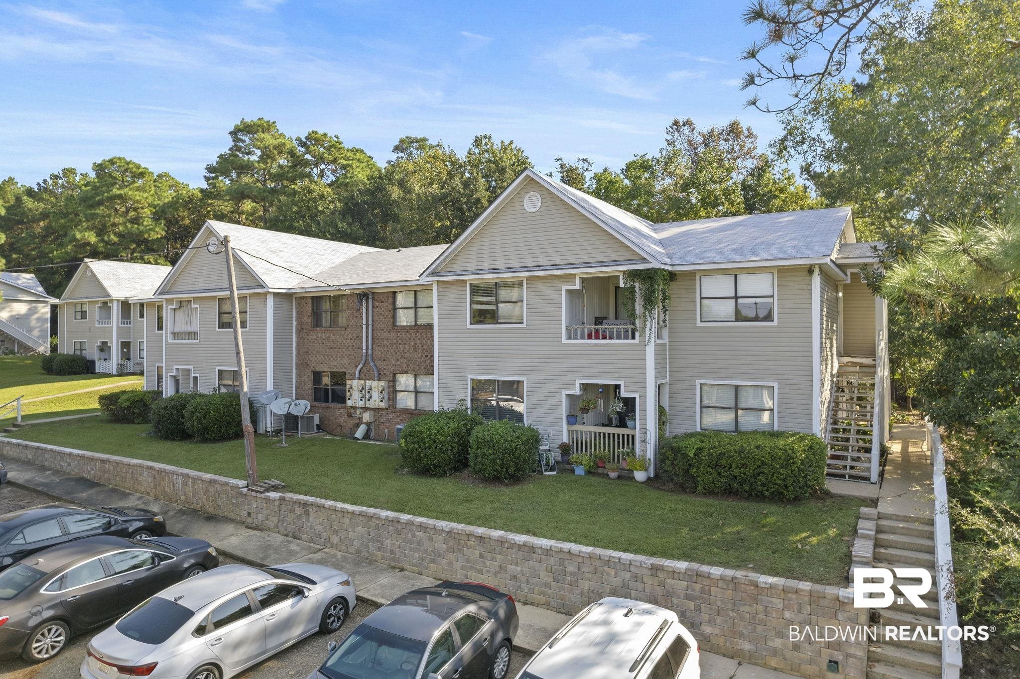 110 5th Street, Unit C103 Daphne, AL 36526 - Photo 3 of 46 View of front of property featuring a front yard and a balcony