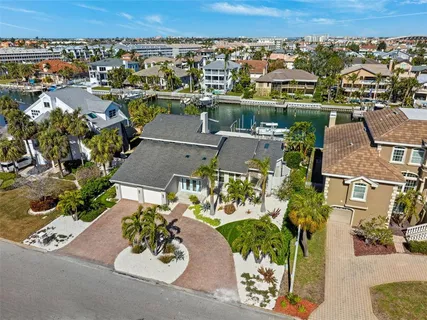 an aerial view of a house with a garden and lake view