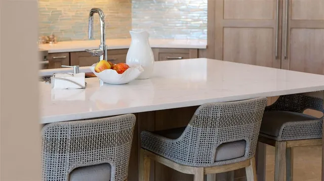 a spacious bedroom with a bed a couch and large window