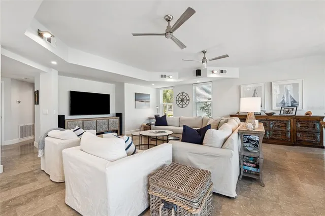 a spacious bedroom with a bed a couch and a window