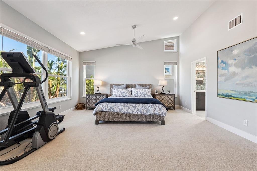 123 8th Street East Tierra Verde, FL 33715 - Photo 34 of 87 a spacious bedroom with a bed a couch and a painting on the wall