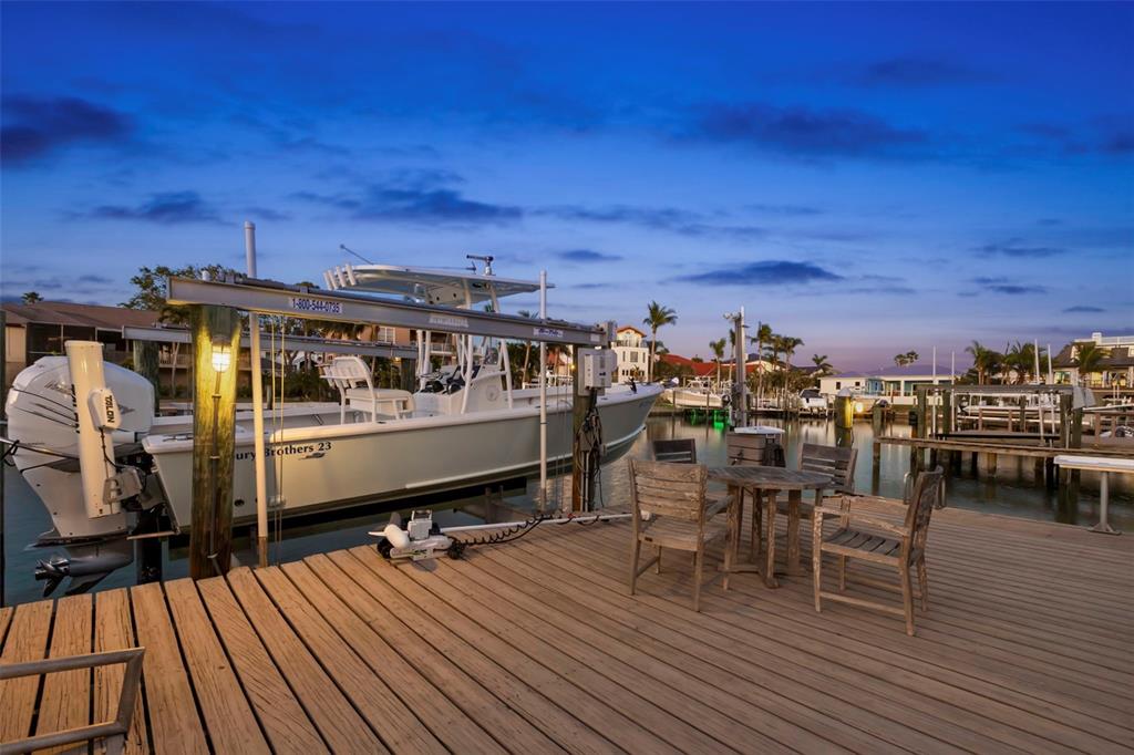 123 8th Street East Tierra Verde, FL 33715 - Photo 74 of 87 a view of a chairs and table on the wooden deck