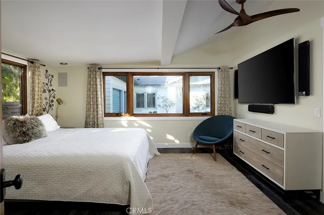 a bedroom with a bed and flat screen tv