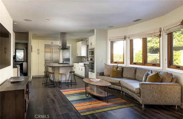 a living room with furniture wooden floor and a table