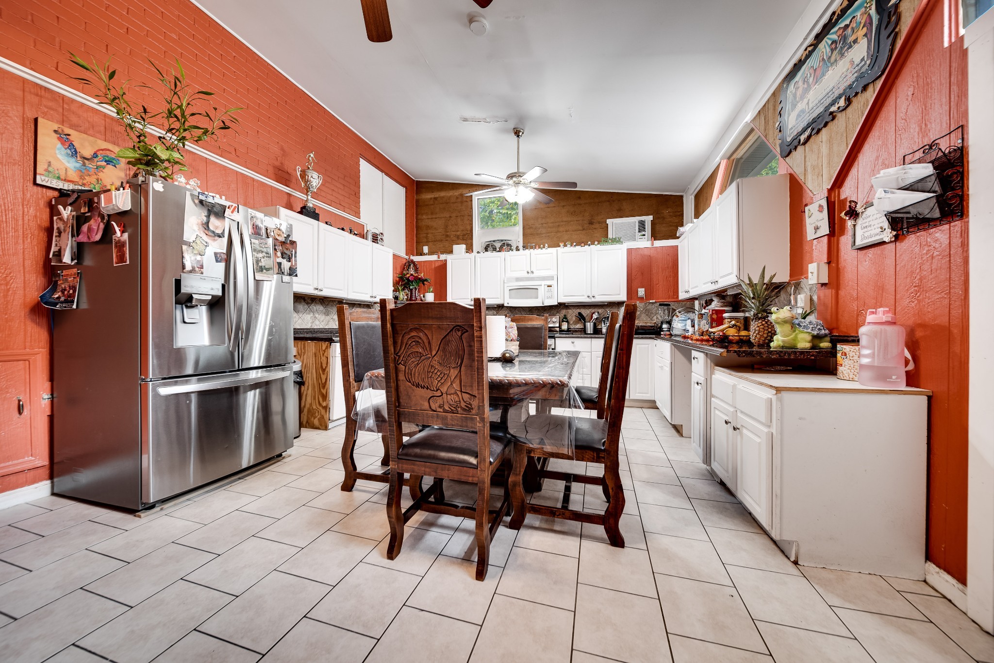 709 Florence Circle Madison, TN 37115 - Photo 23 of 39 a kitchen with stainless steel appliances kitchen island granite countertop a table chairs and a refrigerator