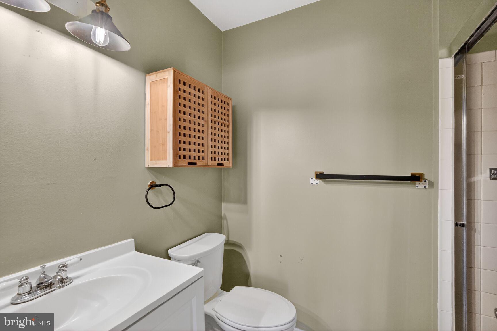15320 Pine Orchard Drive, Unit 83C1 Silver Spring, MD 20906 - Photo 11 of 21 a white toilet sitting next to a bathroom sink