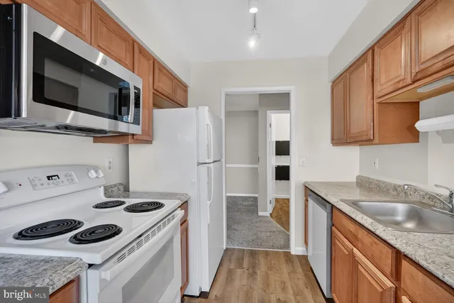 a kitchen with a sink a stove and cabinets