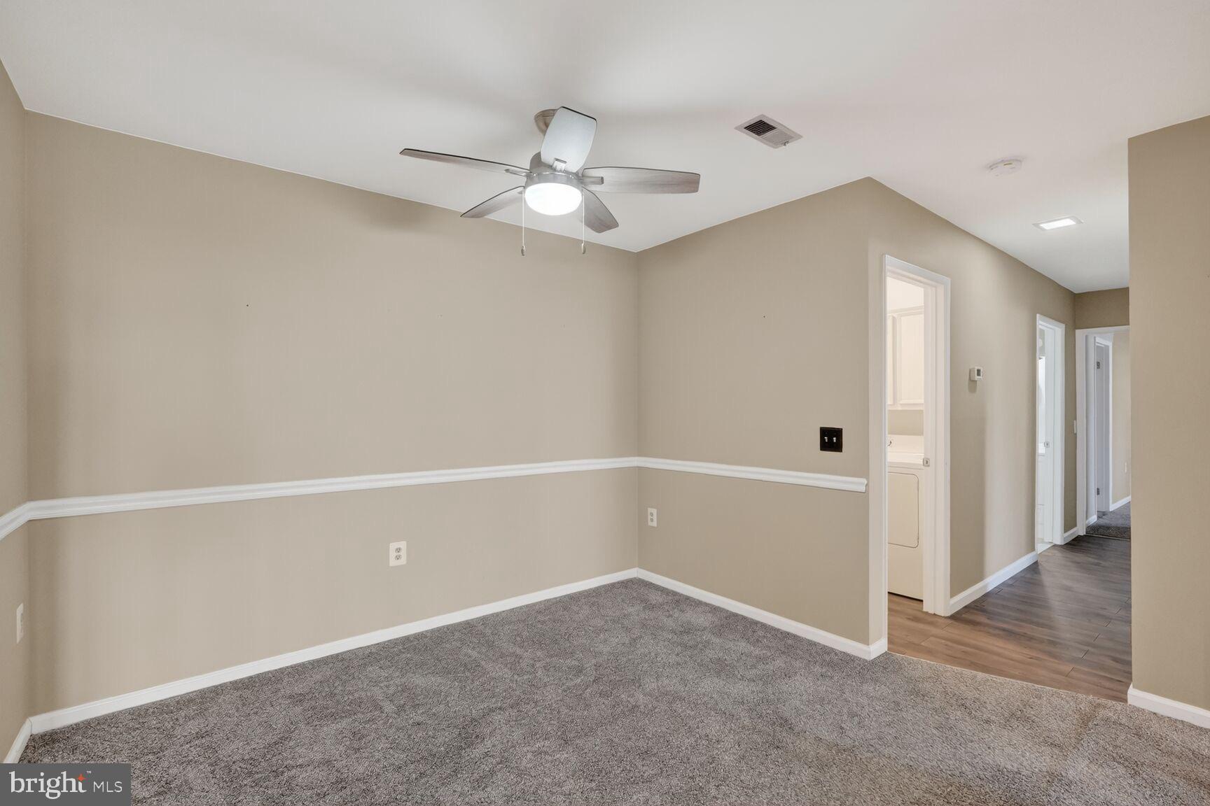 15320 Pine Orchard Drive, Unit 83C1 Silver Spring, MD 20906 - Photo 6 of 21 an empty room with chandelier fan and closet