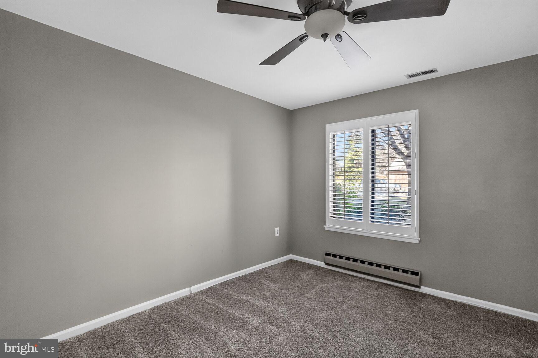15320 Pine Orchard Drive, Unit 83C1 Silver Spring, MD 20906 - Photo 8 of 21 an empty room with windows and fan