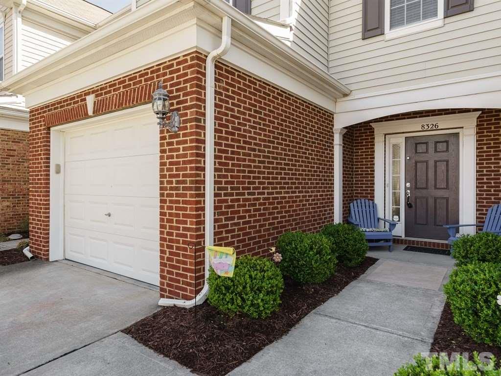 8326 Pilots View Drive Raleigh, NC 27617 - Photo 2 of 25 a front view of a house with a garage