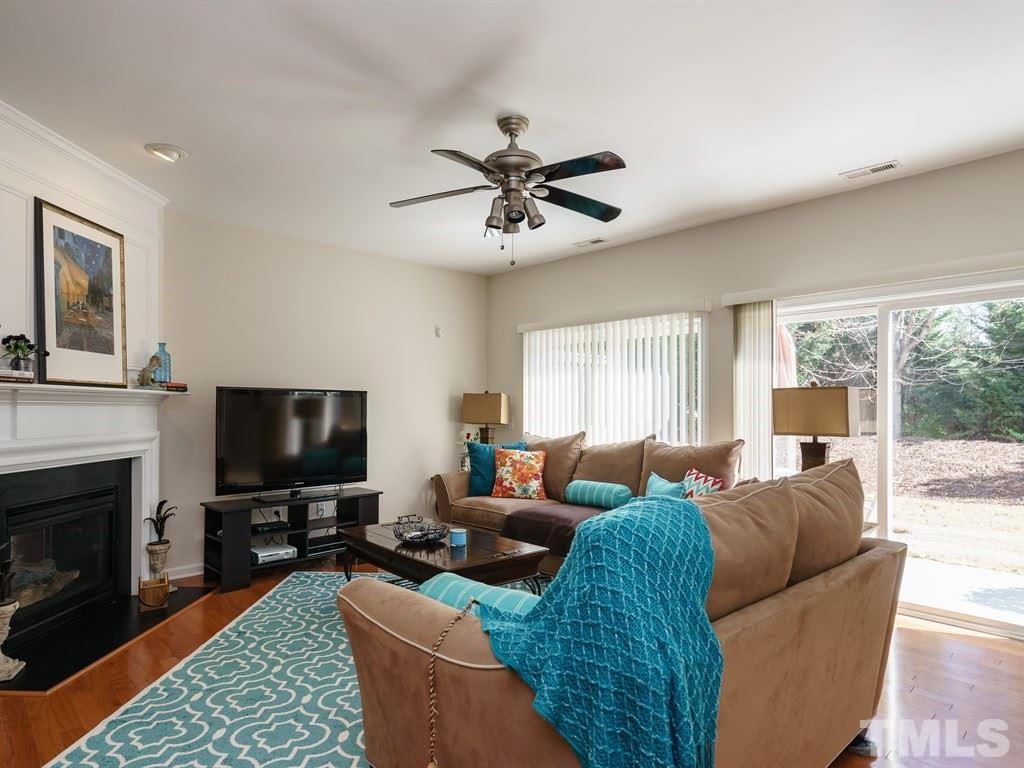 8326 Pilots View Drive Raleigh, NC 27617 - Photo 11 of 25 a living room with furniture a flat screen tv and a fireplace