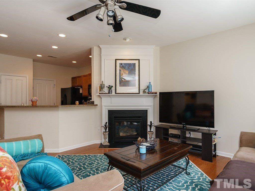 8326 Pilots View Drive Raleigh, NC 27617 - Photo 12 of 25 a living room with furniture a flat screen tv and a fireplace