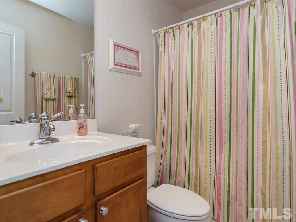 8326 Pilots View Drive Raleigh, NC 27617 - Photo 19 of 25 a bathroom with a sink a toilet and shower curtain