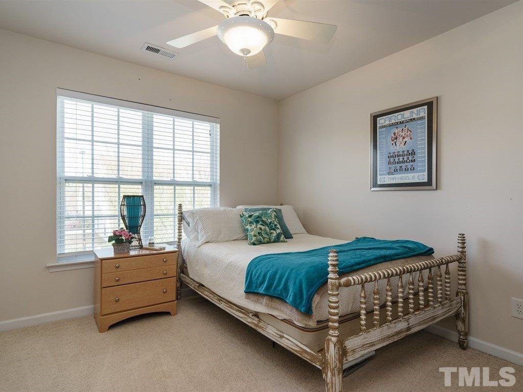 8326 Pilots View Drive Raleigh, NC 27617 - Photo 20 of 25 a bedroom with a bed and a window