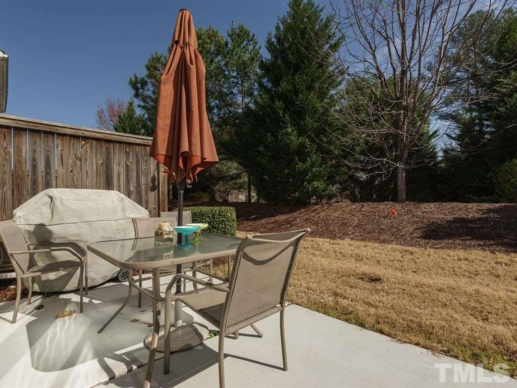 8326 Pilots View Drive Raleigh, NC 27617 - Photo 21 of 25 a view of backyard with table and chairs and wooden fence