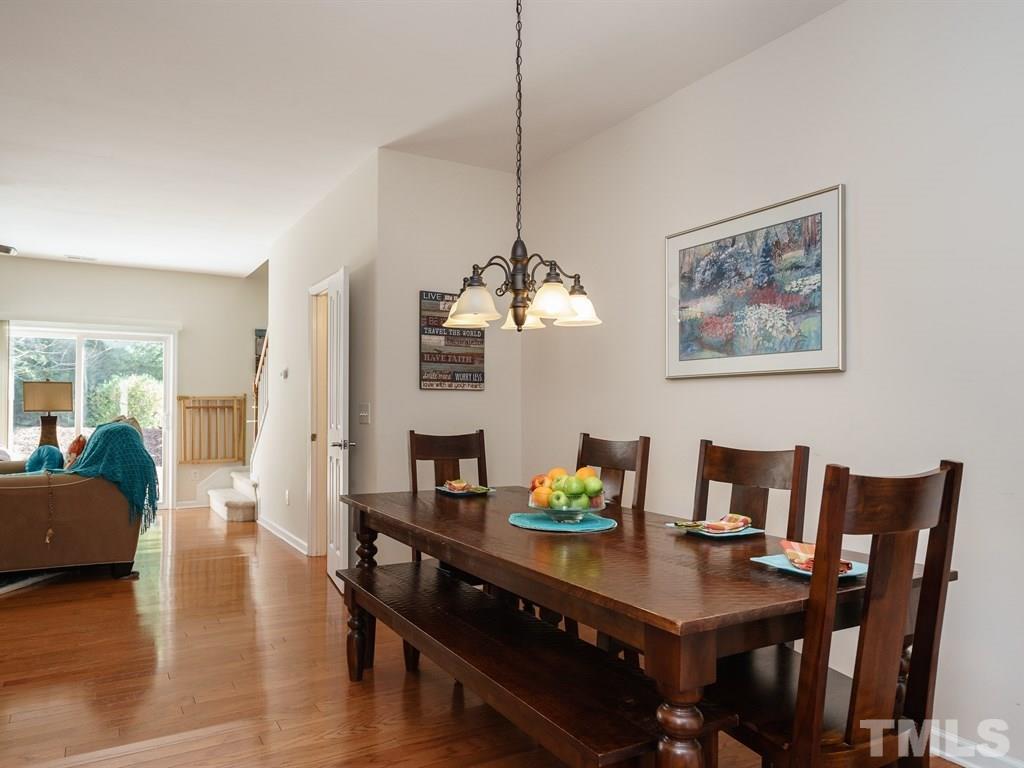 8326 Pilots View Drive Raleigh, NC 27617 - Photo 5 of 25 a view of a dining room with furniture wooden floor and a chandelier