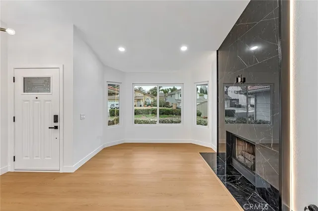 a view of hallway with cabinets and wooden floor