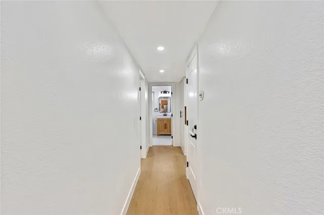 a view of a hallway with wooden floor