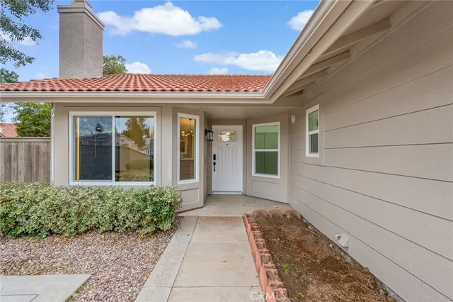 front view of a brick house with a large window